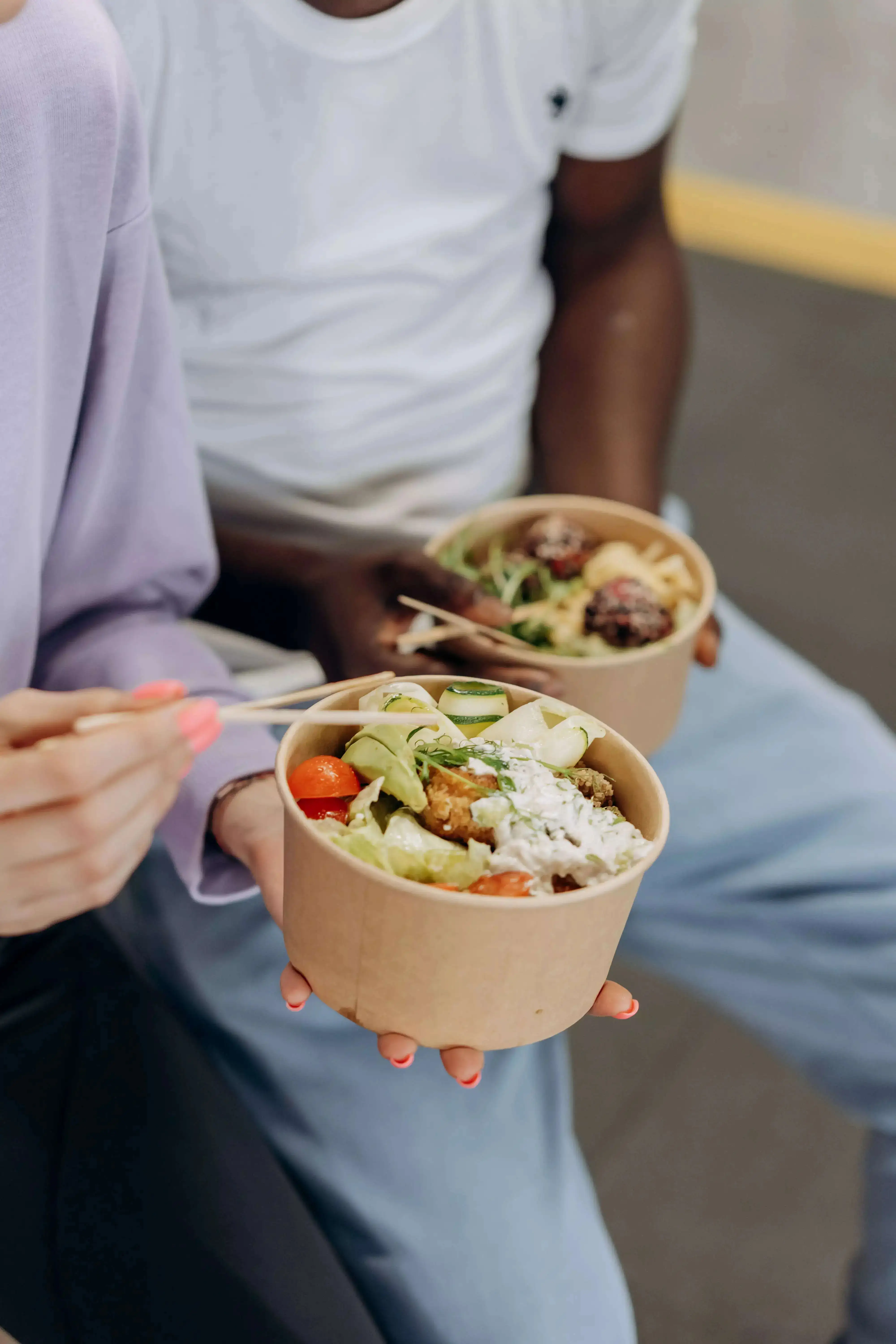 A boy and girl eating from small bowls