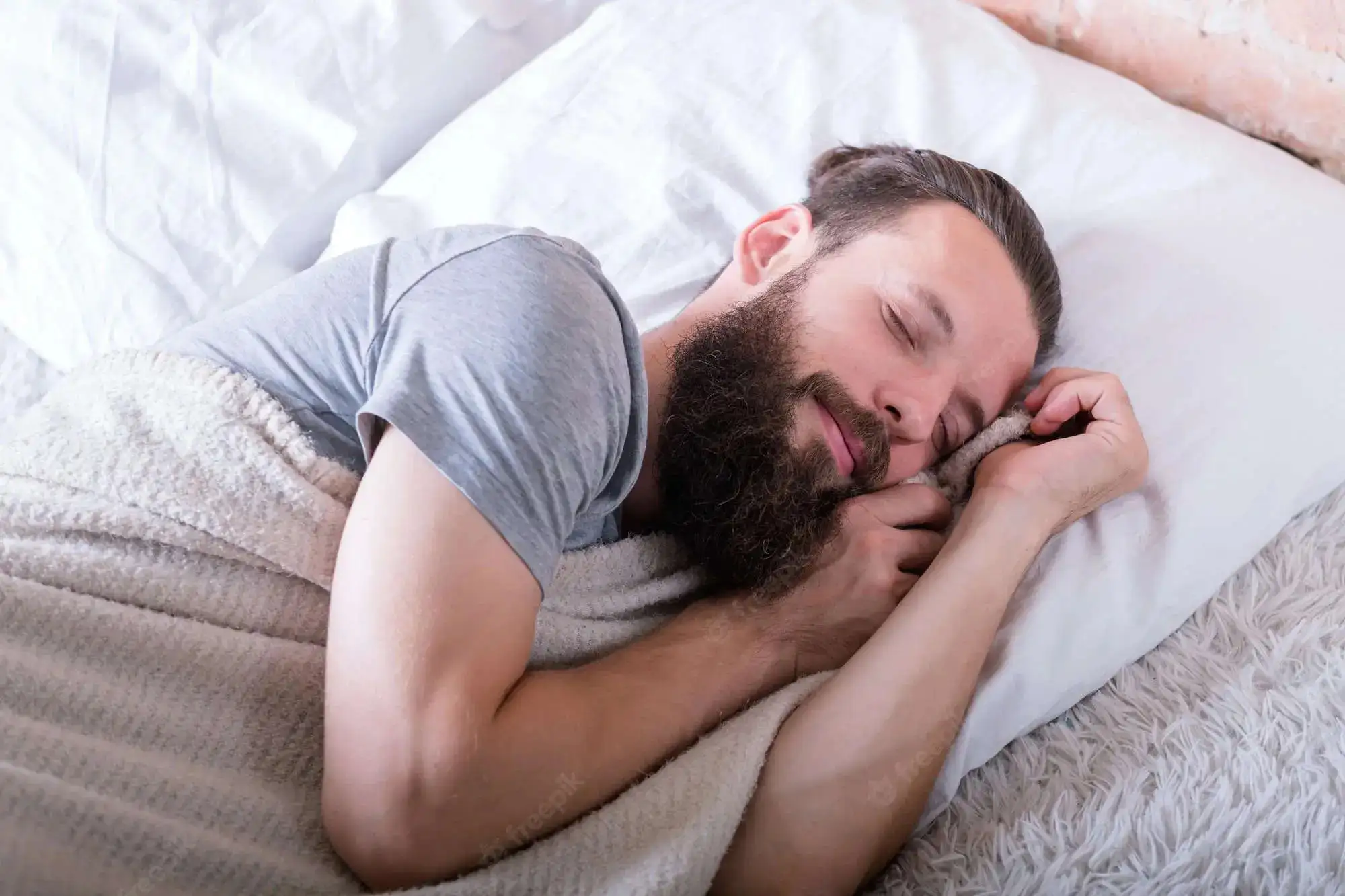 peaceful-healthy-sleep-comfy-softness-warm-bed-man-sleeping-with-happy-facial-expression-calm-coziness_279525-3248.