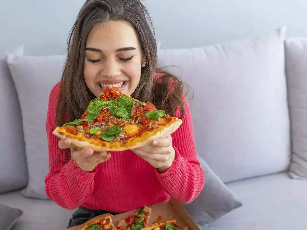 A girl eating pizza