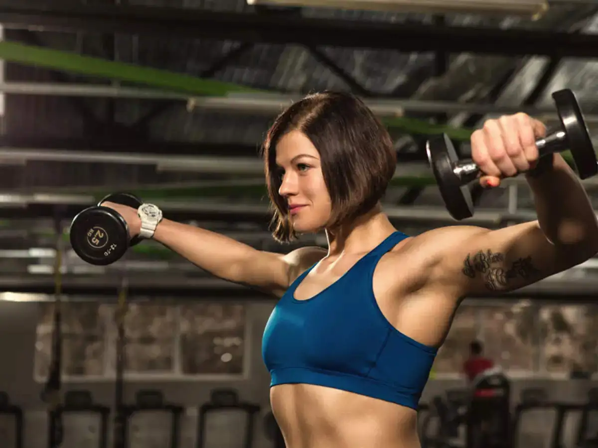 A woman doing shoulder workout using dumbbells