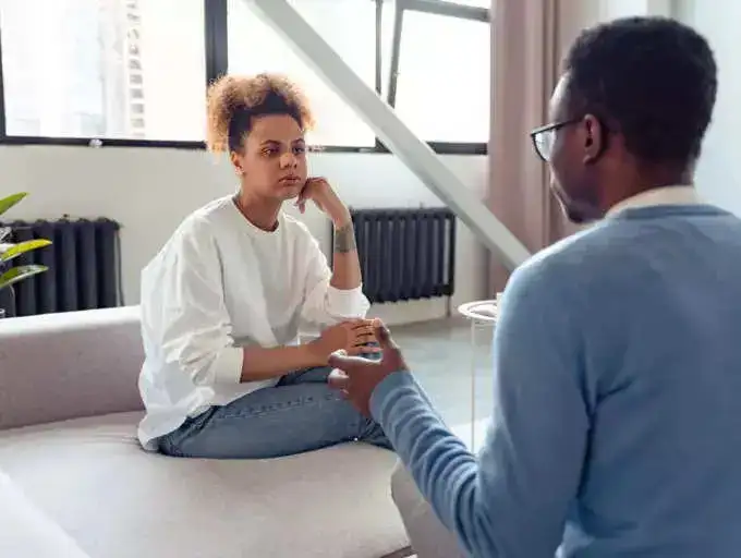 A woman listening to a man