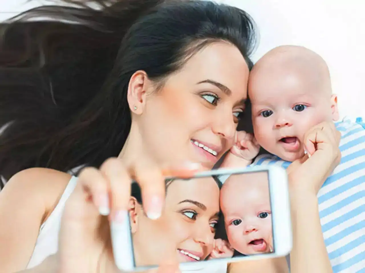 A mother taking a selfie of her young born