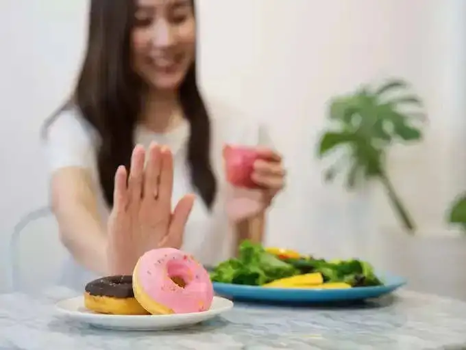 A girl saying no to donuts