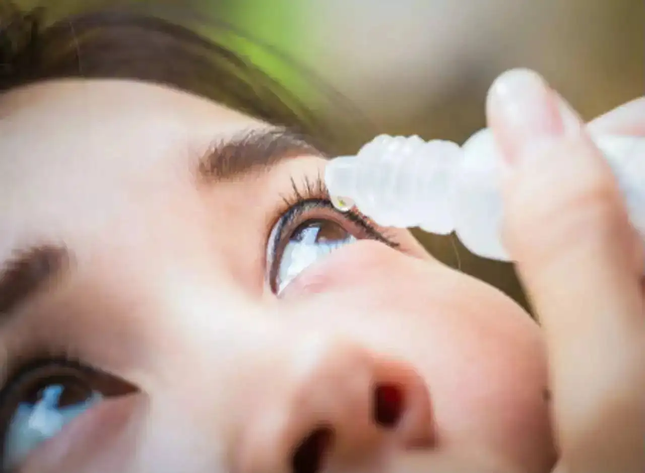 A woman using artificial tears