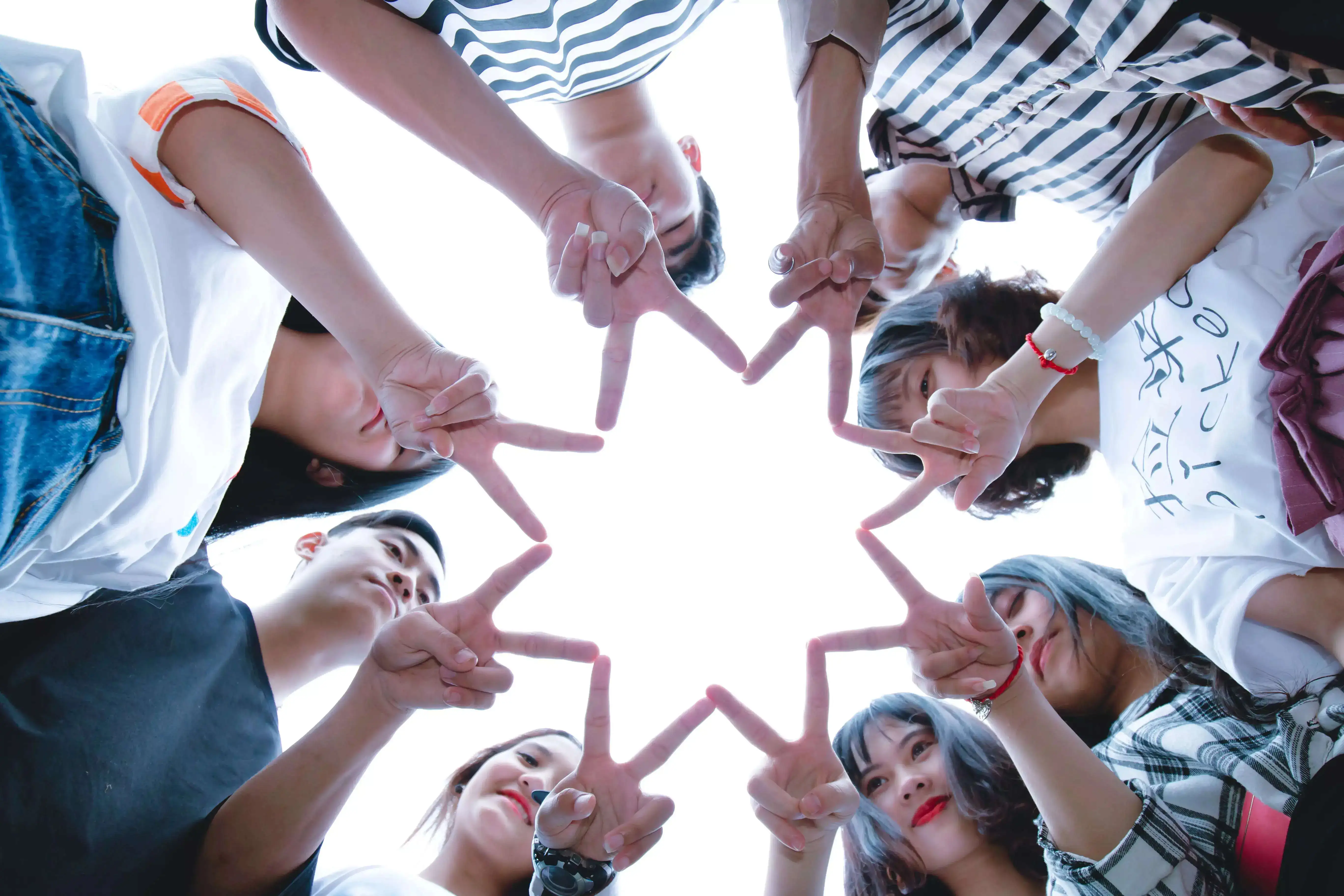 A group of friends making a star with their fingers