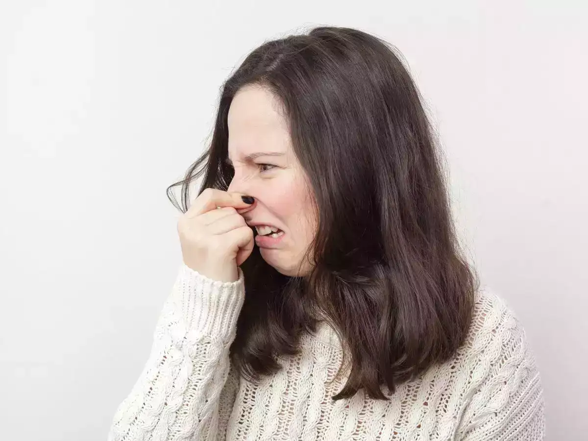 A girl closing her nose