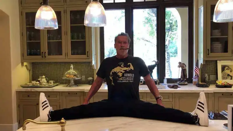 Arnold Schwarzenegger's playful side shines through with kitchen counter splits prank