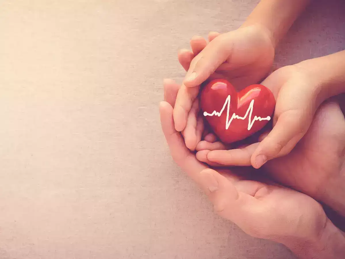 Two people holding a heart in their hands