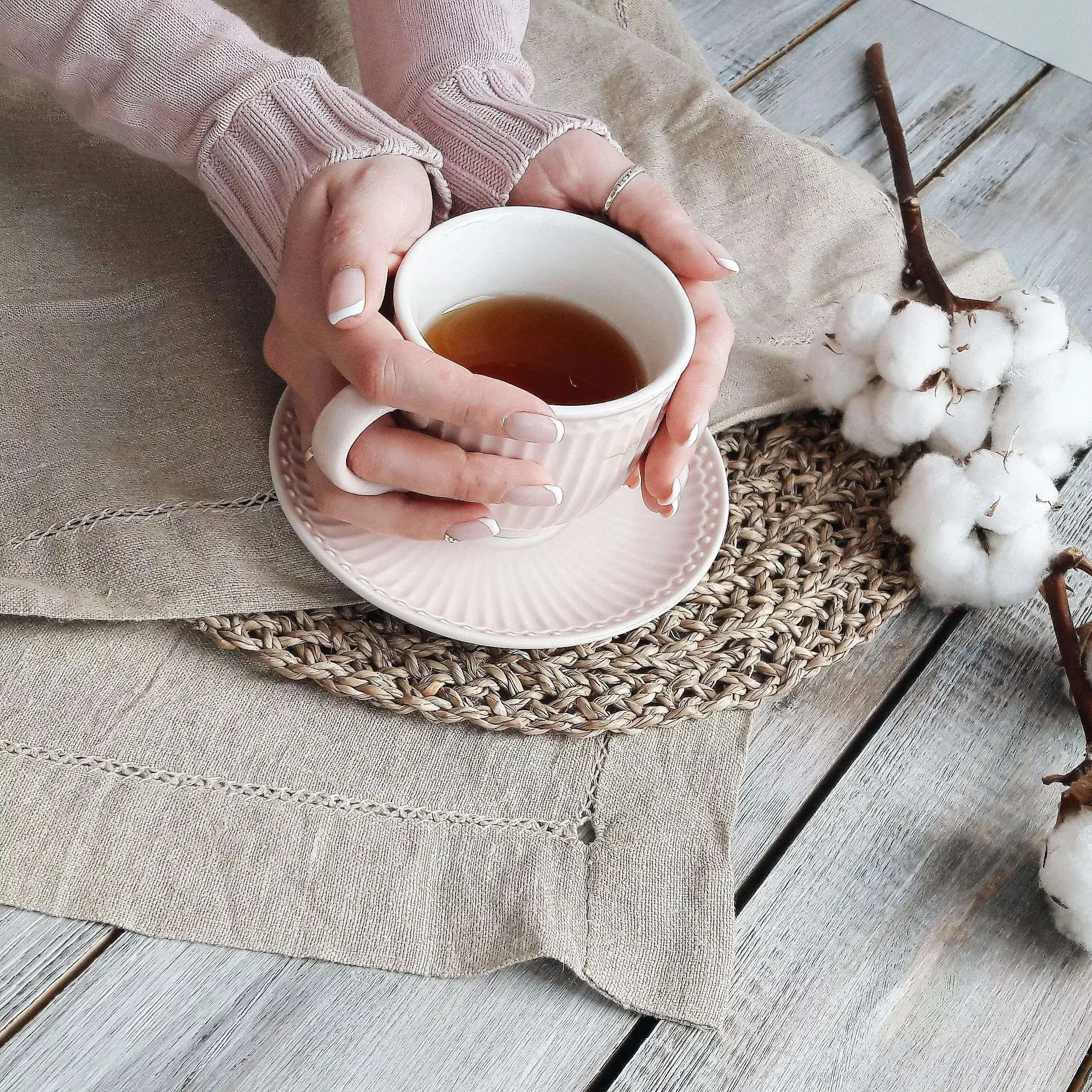 A girl embracing a cup of tea