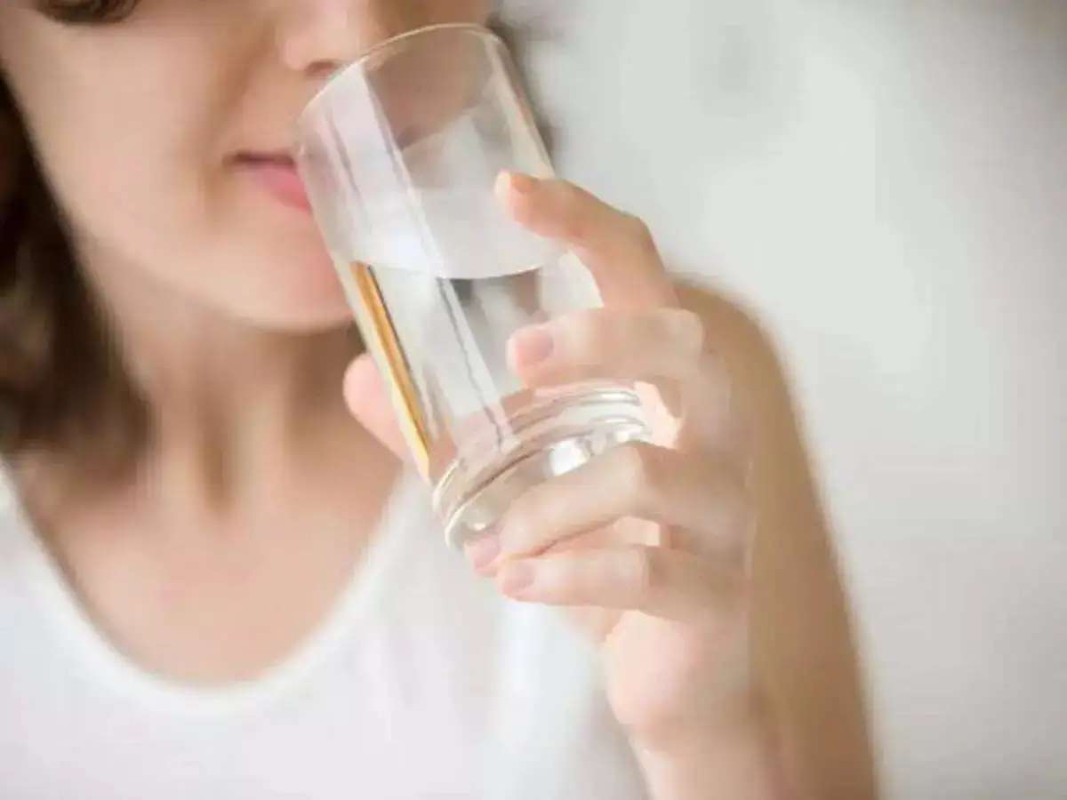 A girl drinking a glass of water