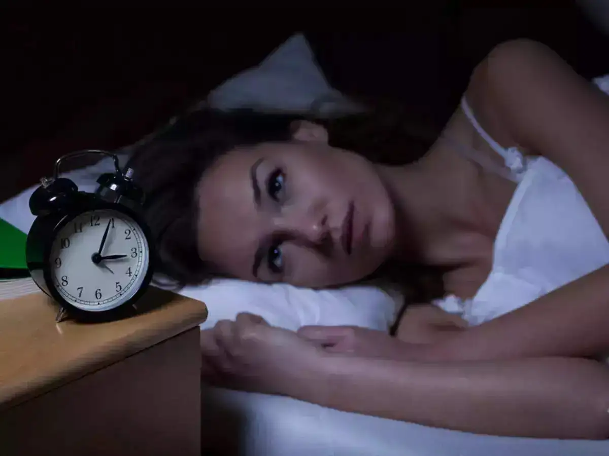 A girl lying on the bed while awake